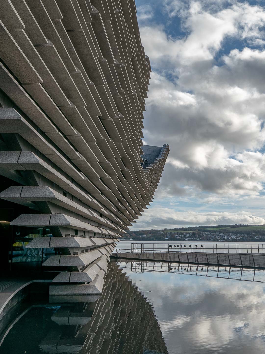 The building floats over a pool that seems like an inlet of the river Tay